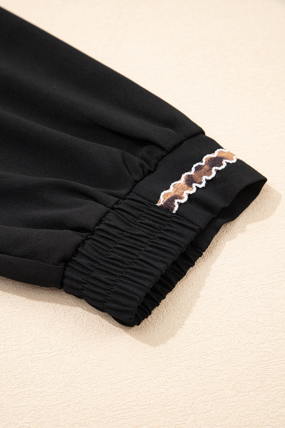 Robe courte noire à col V brodé et manches 3/4 bouffantes